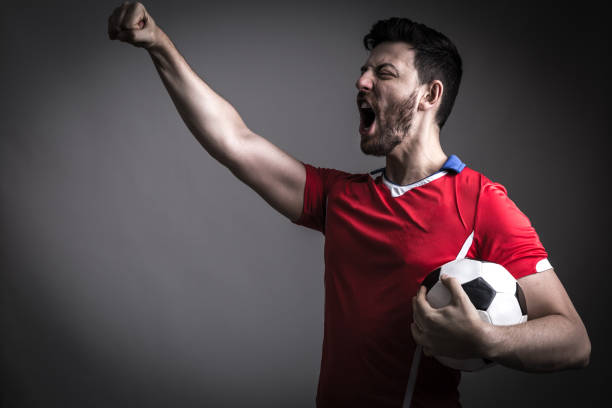 istock Fan / Sport Player on red uniform celebrating 912561660