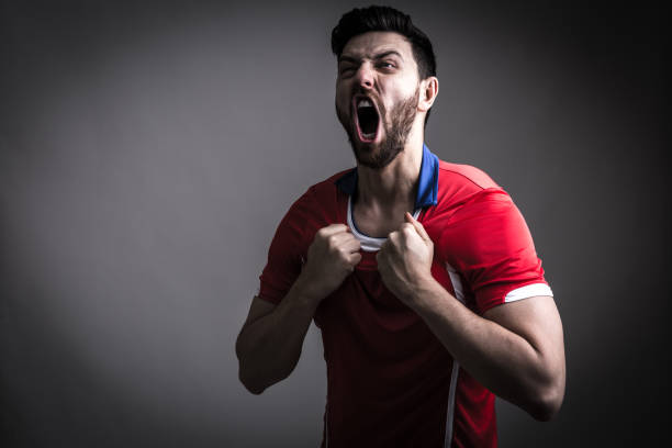tifoso / giocatore sportivo in uniforme rossa che festeggia - belgium morocco foto e immagini stock