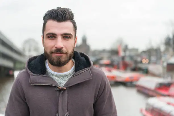 Horizontal color image of a real life Syrian refugee in Amsterdam. Copy space right.