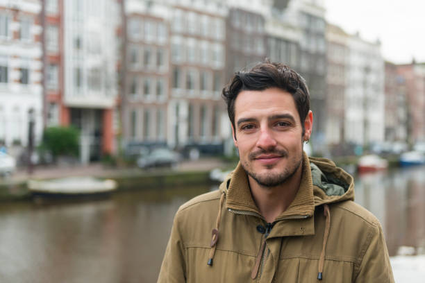 Horizontal color portrait image of young British man in Amsterdam. Copy space left.