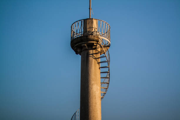 istock Observe tower with spiral stairs in front of blue sky 912574620