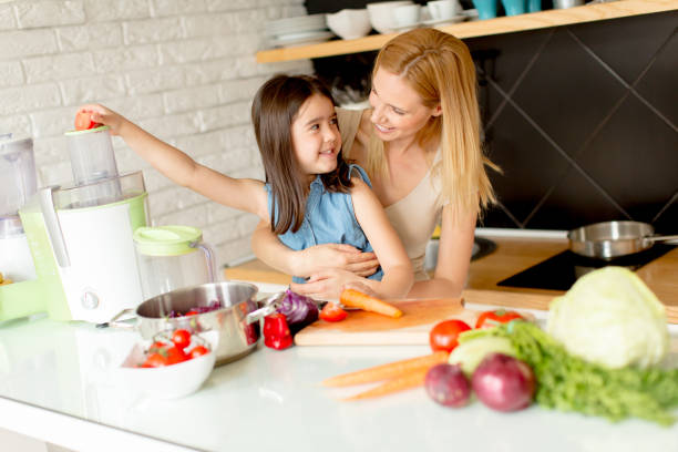 istock Mother and daughter preparing healthy juice 912574868