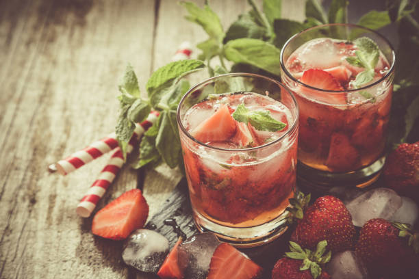 istock Strawberry mojito and ingredients on rustic background 912578382