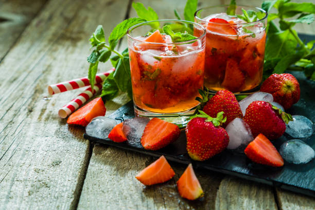 istock Strawberry mojito and ingredients on rustic background 912578468