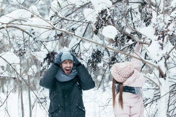 istock young couple having fun together in snowy forest 912585054