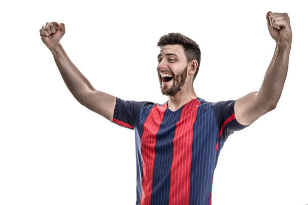 istock Fan / Sport Player on blue and red uniform celebrating on white background 912585652