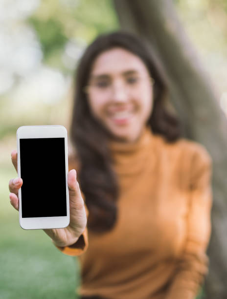 istock woman show smart phone screen 912588332