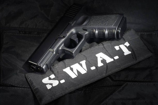 istock SWAT weapon and equipment on black uniform background 912596706