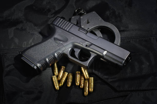 istock Police weapon and equipment on black uniform background 912596818