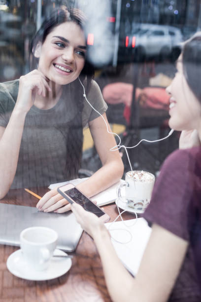istock Enthusiastic two students hearing favorite song 912596862