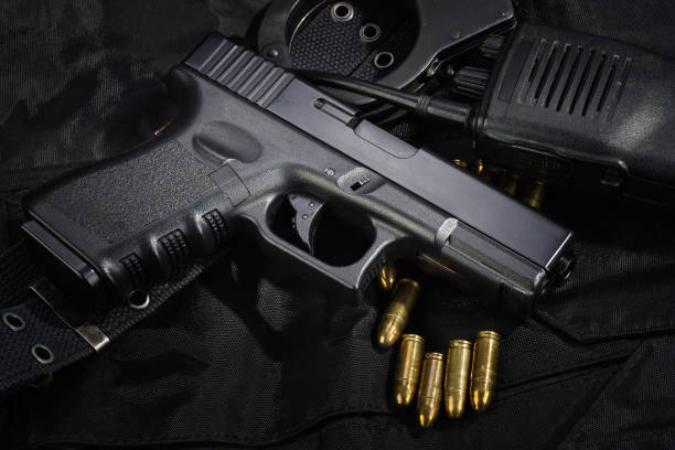 istock Police weapon and equipment on black uniform background 912597044