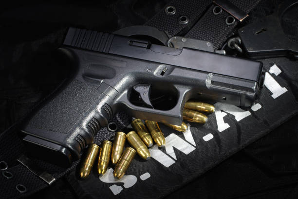istock SWAT weapon and equipment on black uniform background 912597082