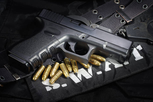 istock SWAT weapon and equipment on black uniform background 912597100