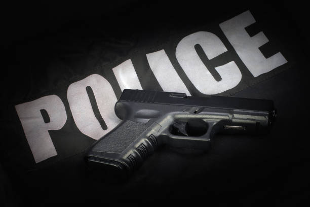 istock Police weapon and equipment on black uniform background 912599082