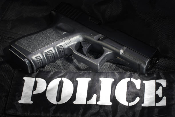 istock Police weapon and equipment on black uniform background 912599252