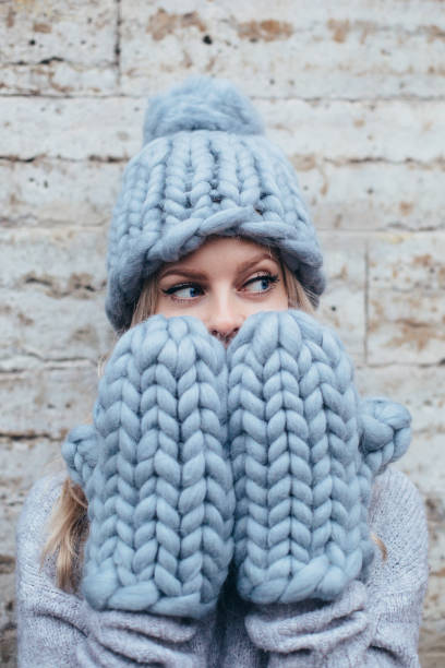 istock Blonde woman in blue knitted hat 912599274