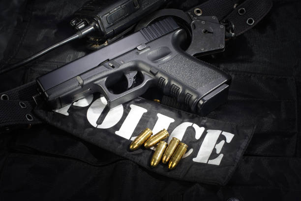 istock Police weapon and equipment on black uniform background 912599480