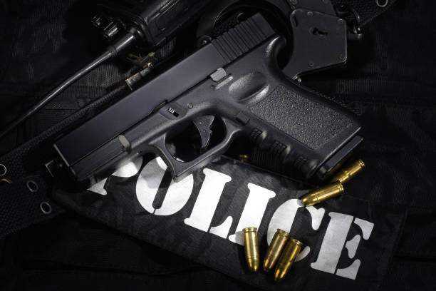 istock Police weapon and equipment on black uniform background 912599916
