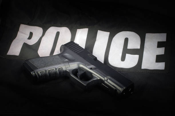 istock Police weapon and equipment on black uniform background 912600428