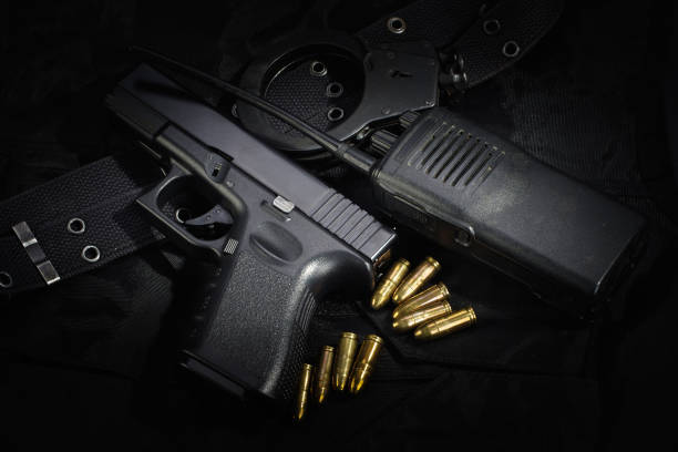 istock Police weapon and equipment on black uniform background 912600556