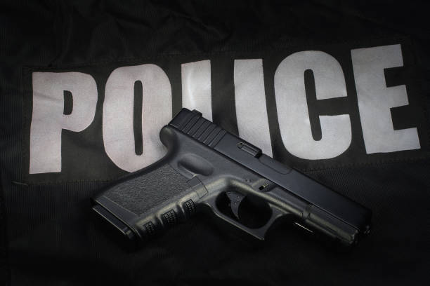 istock Police weapon and equipment on black uniform background 912600668