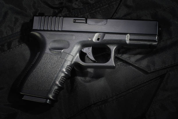 istock Police weapon and equipment on black uniform background 912600734