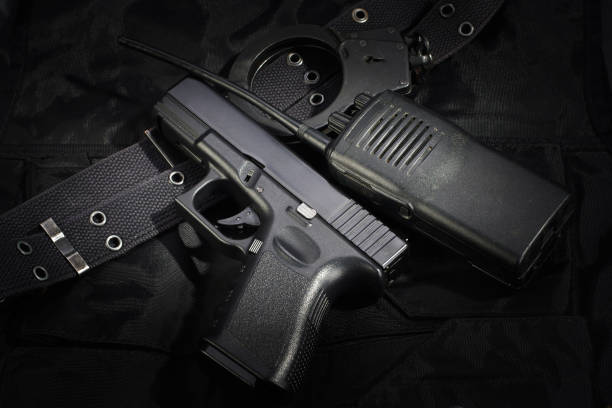 istock Police weapon and equipment on black uniform background 912600758