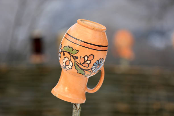Ukrainian clay jug on a wooden fence