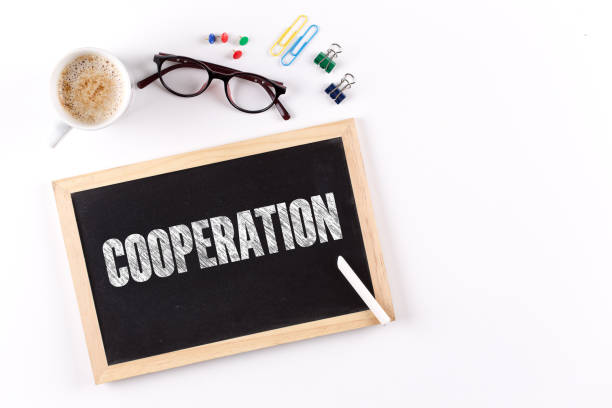 istock COOPERATION word on Chalkboard with Coffee Cup, view from above 912603828