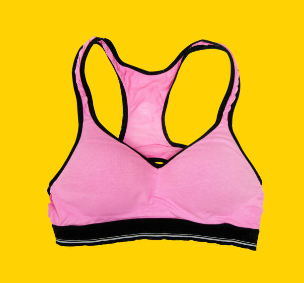 istock Pink sporty bra on yellow background 912604294