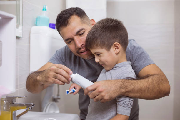 istock Father And Son Brushing Their Theet 912611480