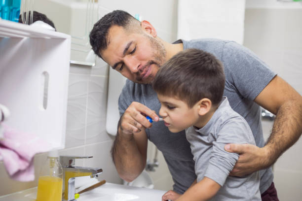 istock Father And Son Brushing Their Theet 912611498