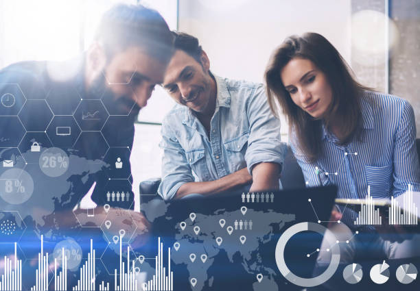 istock Coworking process in a sunny office.Young Business team making great solution at meeting room.Concept of digital diagram,graph interfaces,virtual screen,connections icon on blurred background. 912611536