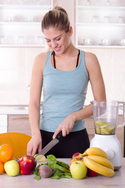 istock Girl preparing smoothie in kitchen 912613320