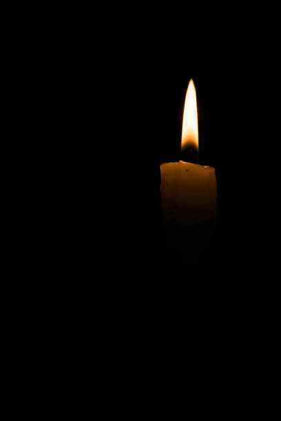 istock Isolated candle light on black background with space for text 912613610