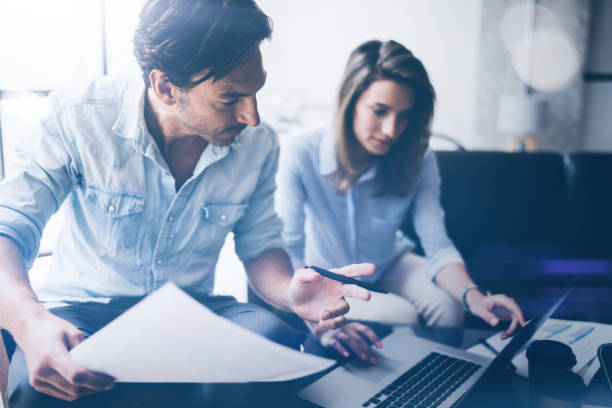 istock Teamwork concept.Young business people working with new startup project.Blurred background,flare.Horizontal. 912614140