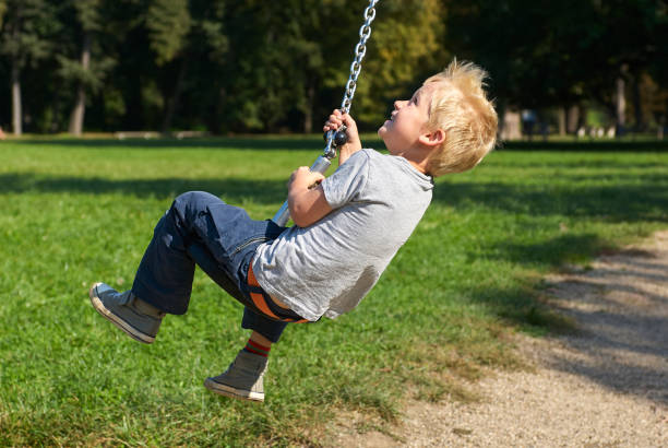 istock Child boy rides on Flying Fox play equipment 912617336