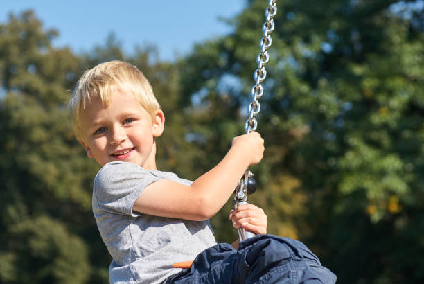 istock Child boy rides on Flying Fox play equipment 912617340