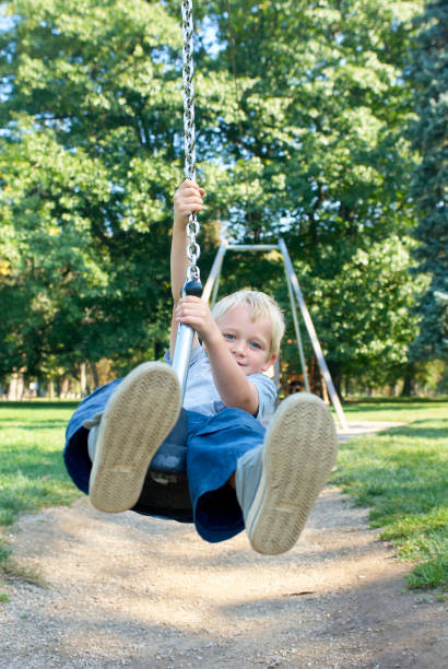 istock Child boy rides on Flying Fox play equipment 912617626
