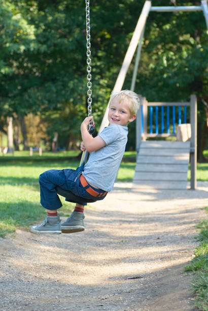 istock Child boy rides on Flying Fox play equipment 912617780