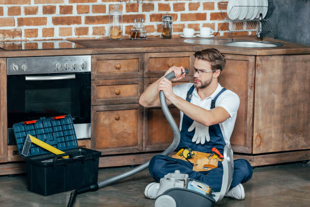 istock young repairman in protective glasses checking broken vacuum cleaner 912617846