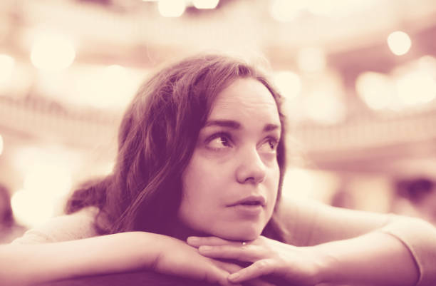 closeup portrait of bored young woman looking theatre performance