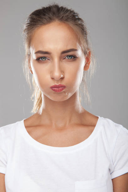 istock upset beautiful young woman is blowing her cheeks 912624568