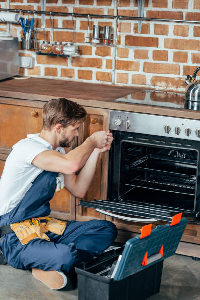 istock high angle view of young repairman fixing oven in kitchen 912624856