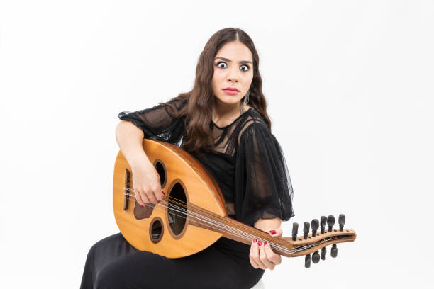 istock Oud playing women. Young woman playing lute string instrument 912628876