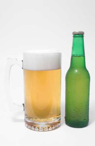 A mug of ice cold beer and a beer in a bottle.