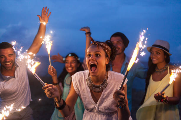 istock Friends celebrating with fireworks on beach at night 912633166
