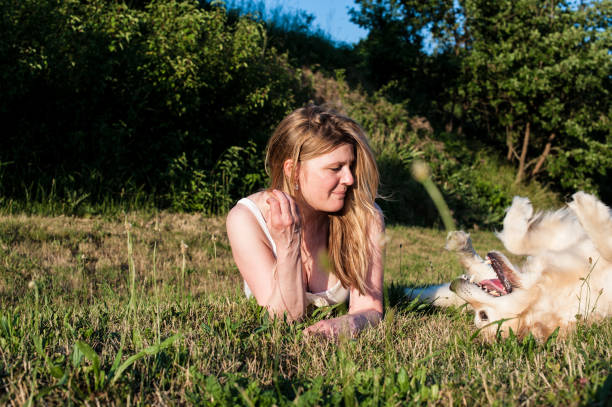 istock Woman Playing with her Dog 912644334
