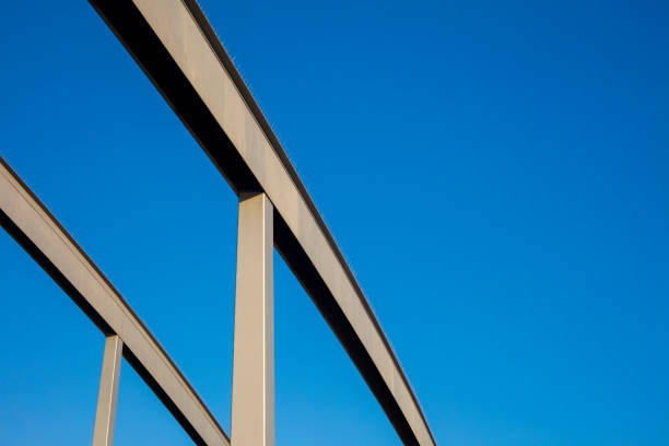 Abstract composition with iron beams in blue sky background.