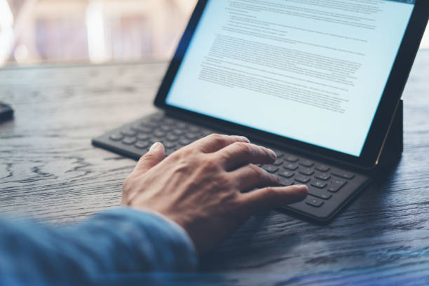 istock View of male hands on electronic tablet keyboard-dock station. Man working at office.Horizontal. 912645306